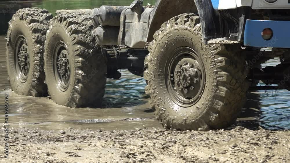 Extreme offroad wheel spinning in a dirty water Extreme offroad wheel spinning in a dirty water