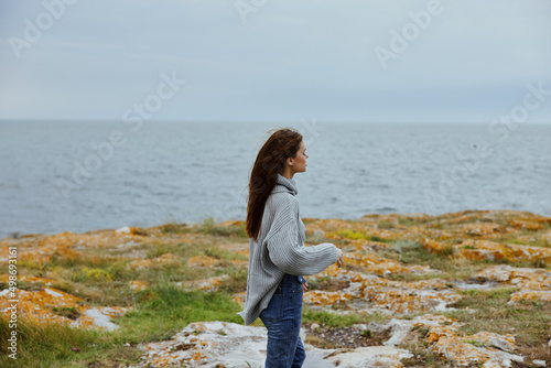 woman freedom walk on the stone coast female relaxing
