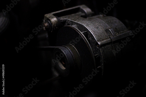 Machine engine in a dark workshop. Automotive parts. The device of transport under the hood.