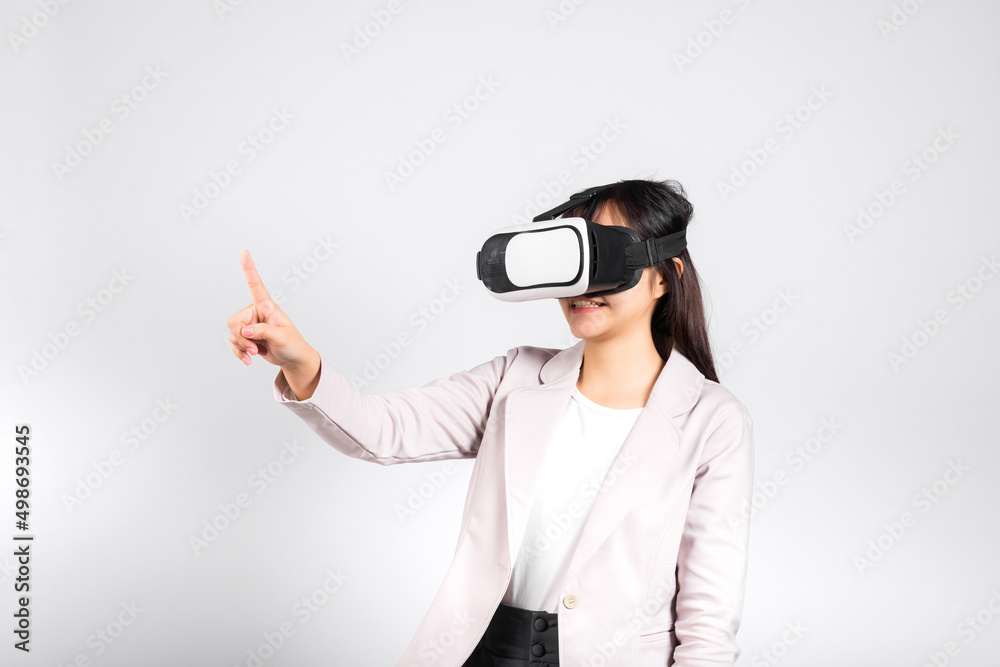 Smiling woman confidence wearing VR headset device touching air during virtual reality experience isolated white background, Asian happy portrait female playing video game studio shot, copy space Smiling woman confidence wearing VR headset device touching air during virtual reality experience isolated white background, Asian happy portrait female playing video game studio shot, copy space