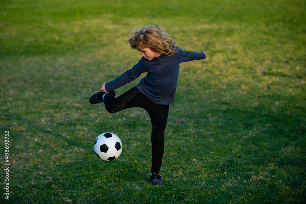 Soccer kid. Kids play football on summer stadium field. Little child