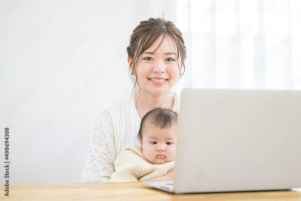Mother working from home with her baby Looking at the camera Mother working from home with her baby Looking at the camera