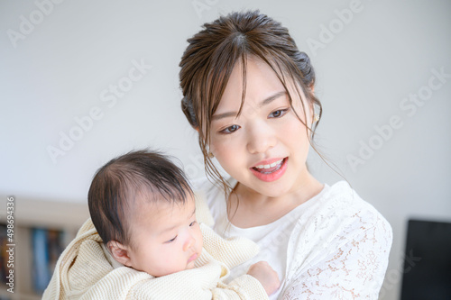 Surprised mother holding her baby