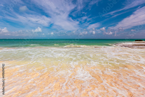 Fototapeta Naklejka Na Ścianę i Meble -  Cancun Mexico beautiful caribbean sea on a sunny day and cloudy sky. sandy beach