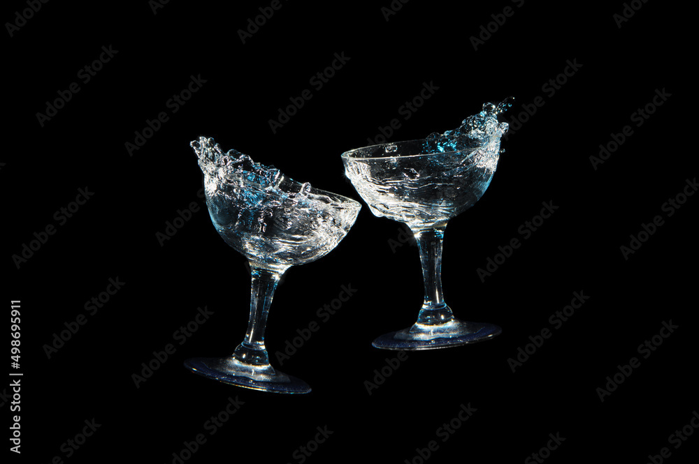 Toast with two wine glass in blue light and white light, isolated on black background Toast with two wine glass in blue light and white light, isolated on black background
