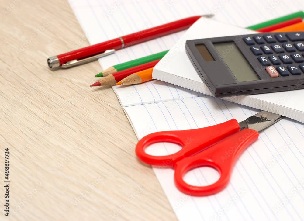 office supplies lie on a white notebook on a wooden table office supplies lie on a white notebook on a wooden table