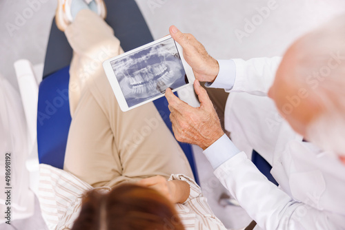 Doctor showing jaw x-ray to patient