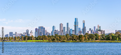 Melbourne cityscape with skyscrapers, blue sky and Yarra River.