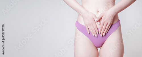 woman in pink panties touching belly as women's health concept photo
