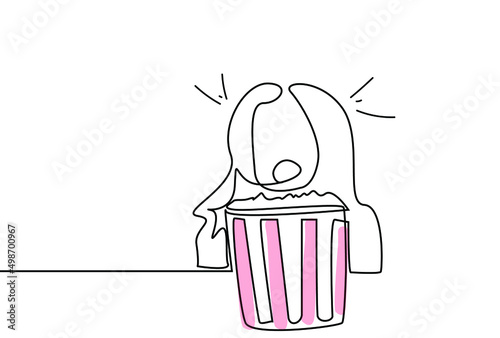 A woman is scared and shocked while watching a movie in front of popcorn from the TV or the cinema.