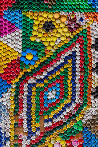 A lot of multi-colored caps from under plastic bottles close-up.