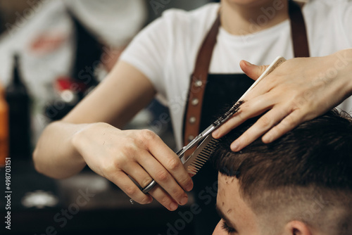 Close-up haircut with scissors. Barbershop