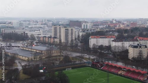 Aerial tilt down from Solna skyline to soccer pitch photo