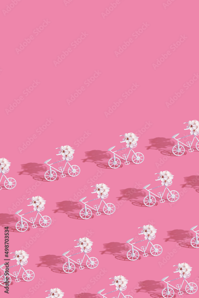 Patternn with decorative bicycles with flowers on pink background. Vertical format with copy space