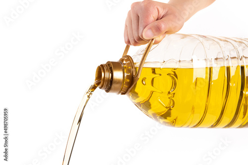 Pouring a bottle of cooking oil isolated on white background