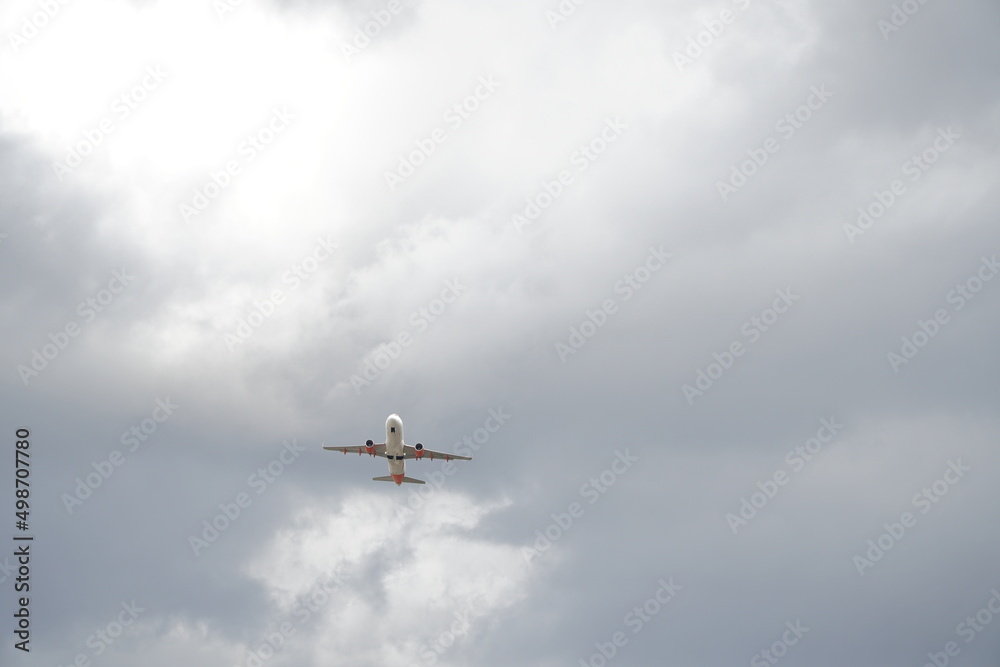Plane is flying in white-grey clouds Plane is flying in white-grey clouds