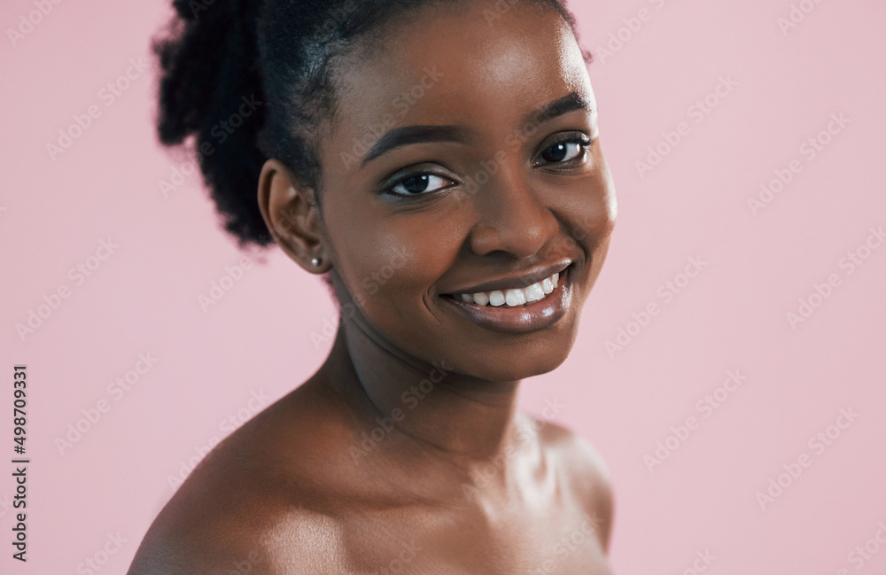 Looking in the camera. Portrait of young african american woman that is against pink background Looking in the camera. Portrait of young african american woman that is against pink background