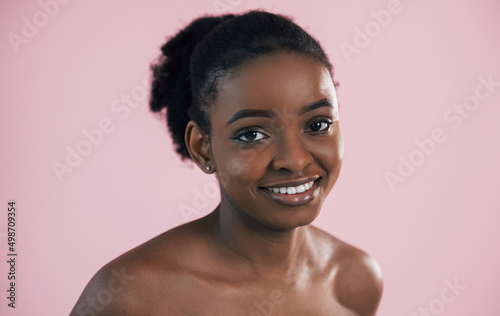 Portrait of young african american woman that is against pink background