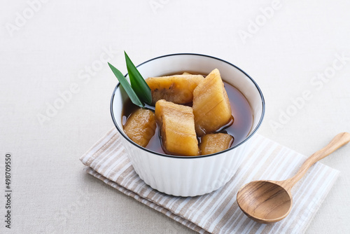 Setup Pisang is traditional dessert made of banana, palm sugar boiled with cinnamon, pandan leaves and cloves. Selective focus image. 
