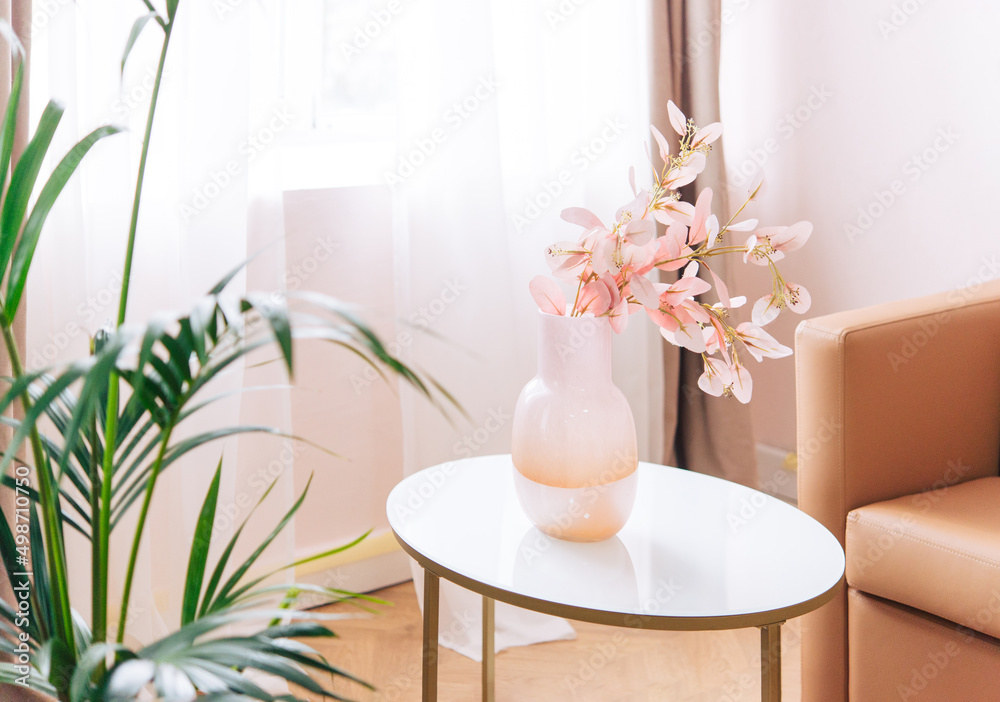 Soft home decor, glass jug, vase with white and pink beautiful flowers against window and curtains and table top. interior.
Soft home decor, glass jug, vase with white and pink beautiful flowers against window and curtains and table top. interior.