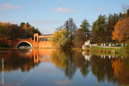 Marfino Manor. View of a pond with a Gothic bridge and griffin sculptures and fountain on the shore. Moscow Region, Russia