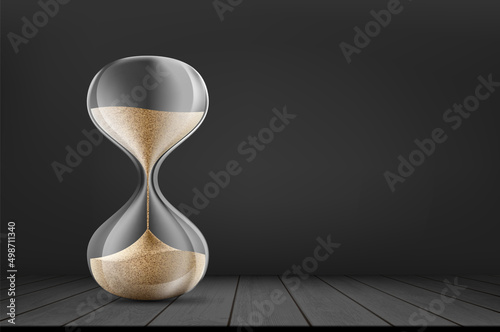 Hourglass on a wooden table. Background with place for text.
