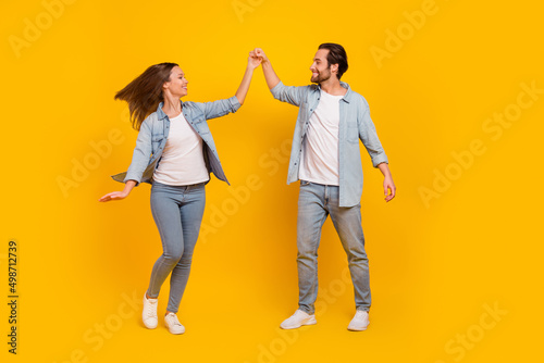 Full length body size view of attractive cheery funny people dancing pastime isolated over bright yellow color background