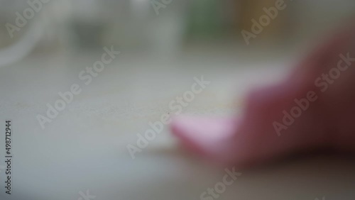 Wallpaper Mural Close-up hand wiping food leftovers with cloth on tablettop indoors. Young unrecognizable Caucasian woman cleaning table at home indoors after lunch dinner Torontodigital.ca