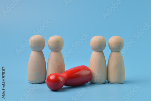 Red wooden doll figure laid on the ground. Layoff, jobless and firing someone concept.