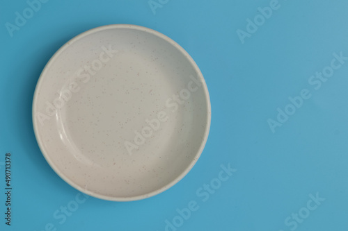 White plate isolated on a blue background