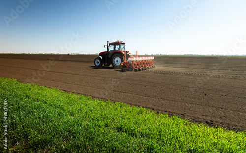 Tractor and seeder for sowing corn photo