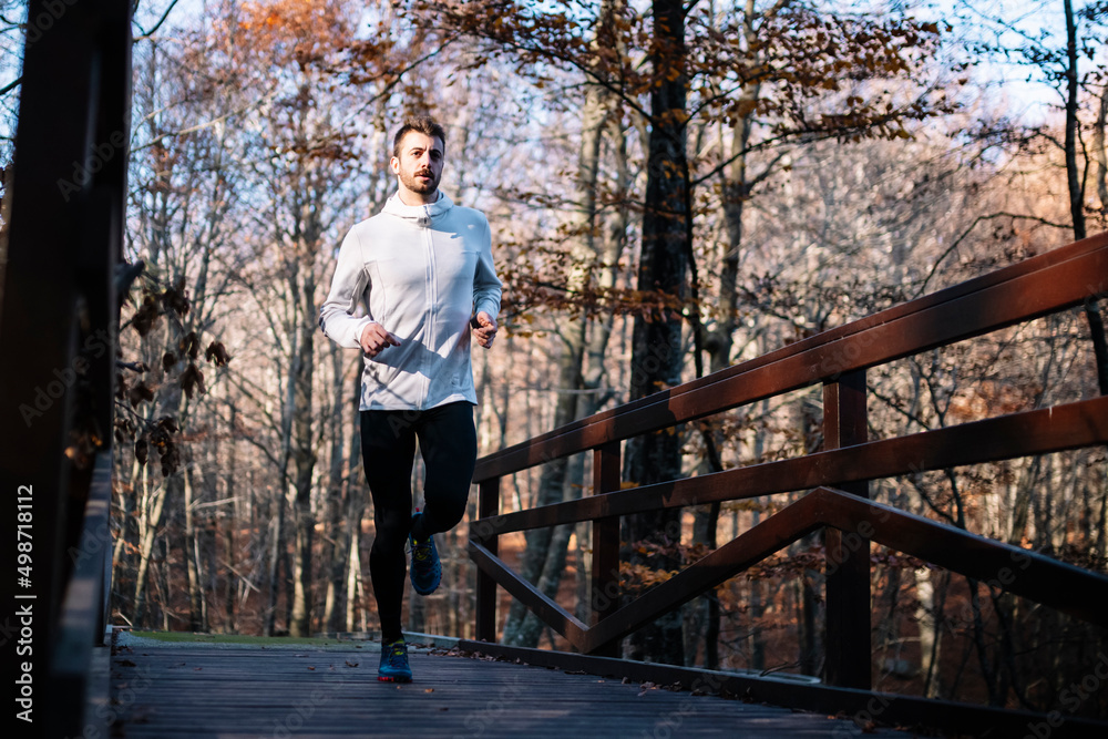 Young man running at park during autumn morning Young man running at park during autumn morning