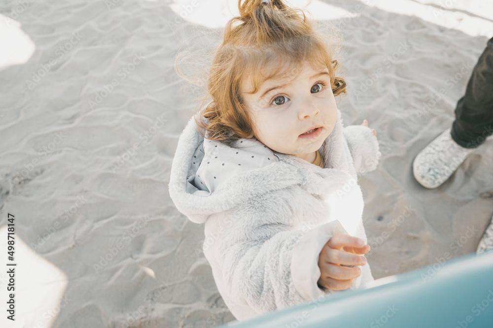 Fototapeta premium Portrait of a little girl in a winter sunny day