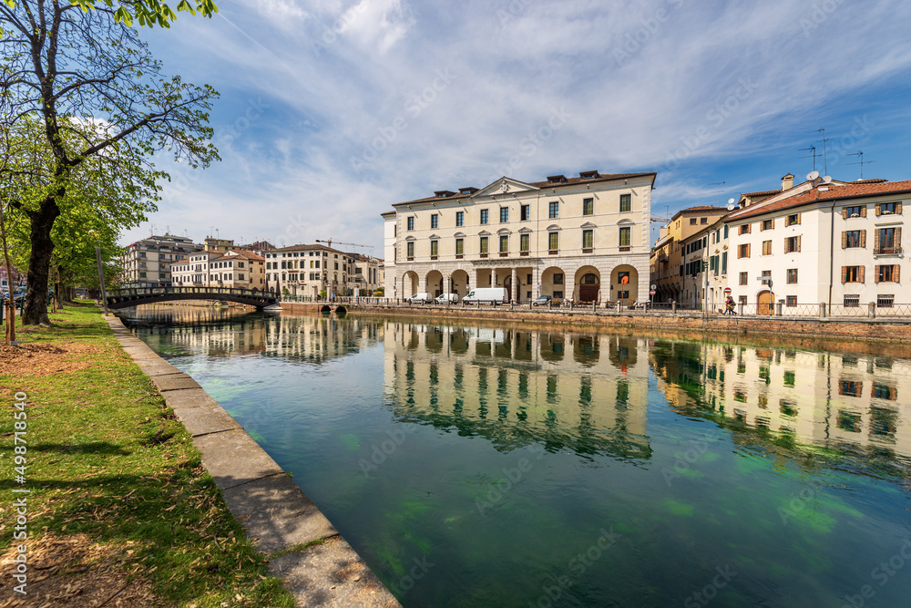 Cityscape of Treviso downtown with the river Sile with the street called Riviera Garibaldi and a small pedestrian bridge. Veneto, Italy, Europe.
