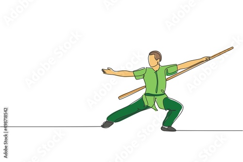Single continuous line drawing of young man wushu fighter, kung fu master in uniform training with long staff at dojo center. Fighting contest concept. Trendy one line draw design vector illustration © Simple Line