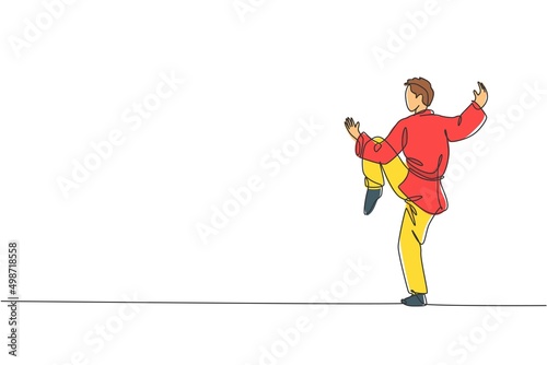 One single line drawing young man on kimono exercising wushu and kung fu stance balance technique on gym center vector illustration graphic. Fighting sport concept. Modern continuous line draw design