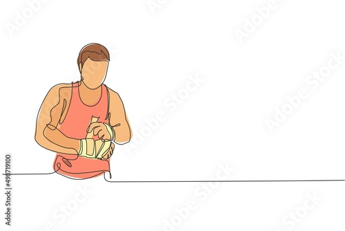 Fotografiet One continuous line drawing of young sporty man kickboxer athlete wrap a strap bandage to prepare a fighting at gym center