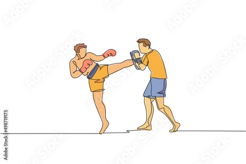 One continuous line drawing of young sporty man kickboxer athlete training with personal trainer who hold punch bag at gym center. Combative sport concept. Single line draw design vector illustration