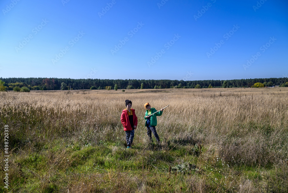 young boys playing in a field. boys running across the field wit