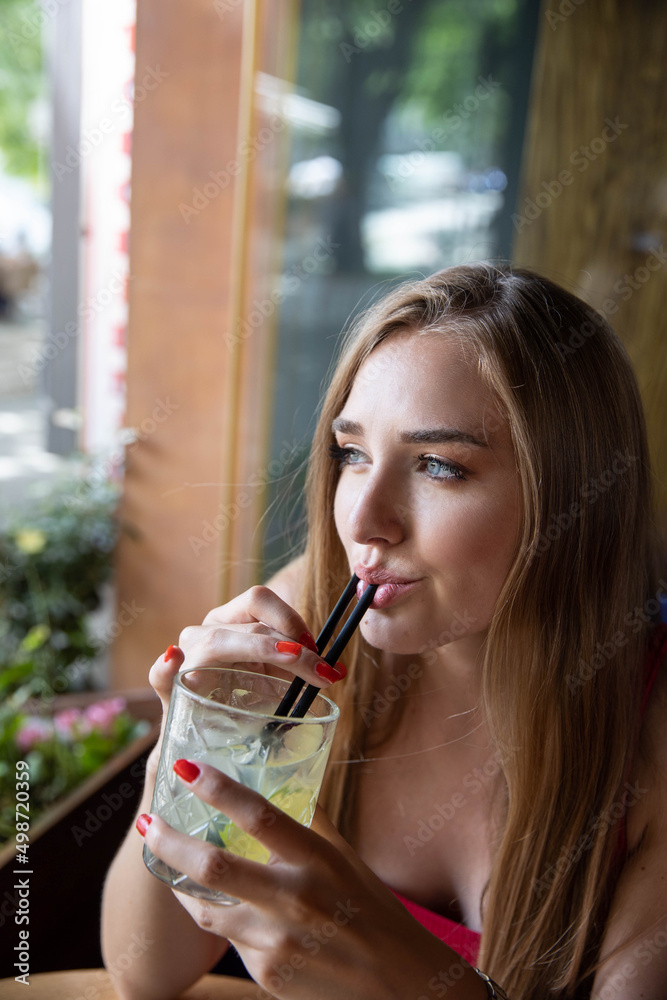 Beautiful young woman drinking cocktail Beautiful young woman drinking cocktail