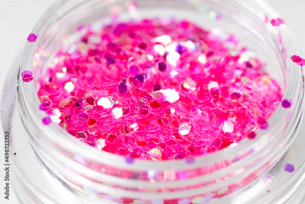 colored sequins in a plastic jar close-up colored sequins in a plastic jar close-up