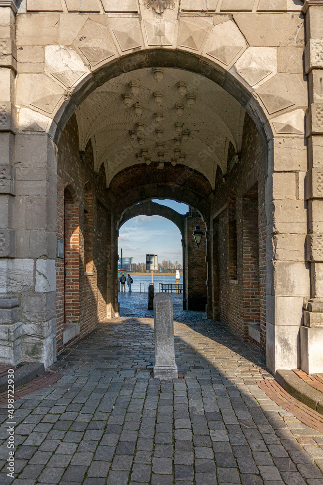 Pedestrians pavement pathway through arched tunnel to the sea in Dordrecht
