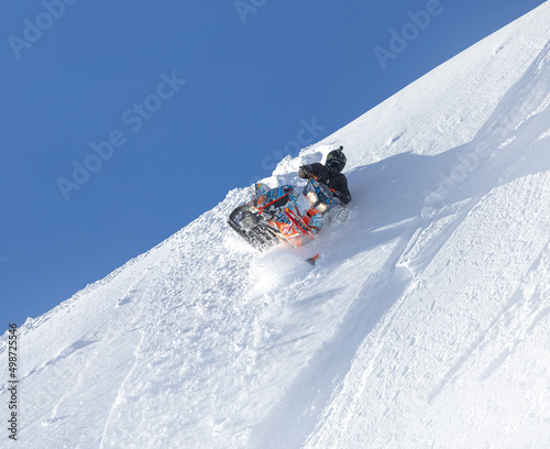 drift mountain snowmobile high in the mountains. photos for advertising and posters about professional tourism in winter on snowmobiles
