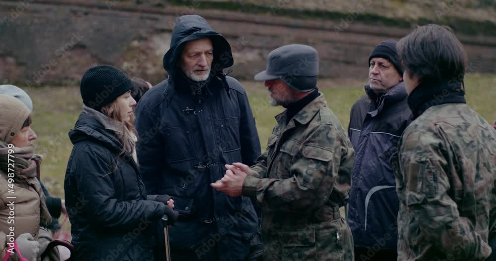 Military Man Discussing Group Of Homeless Refugees. Military Man Discussing Group Of Homeless Refugees.