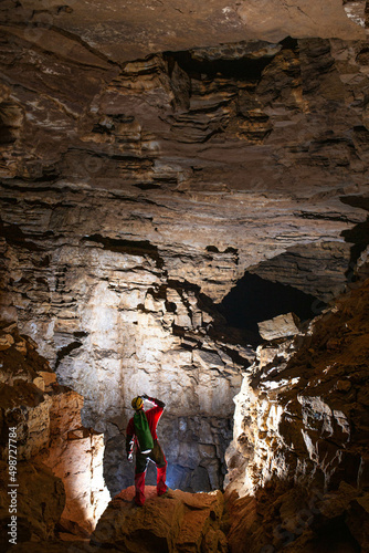 Man is searching a way inside the cave; speleology