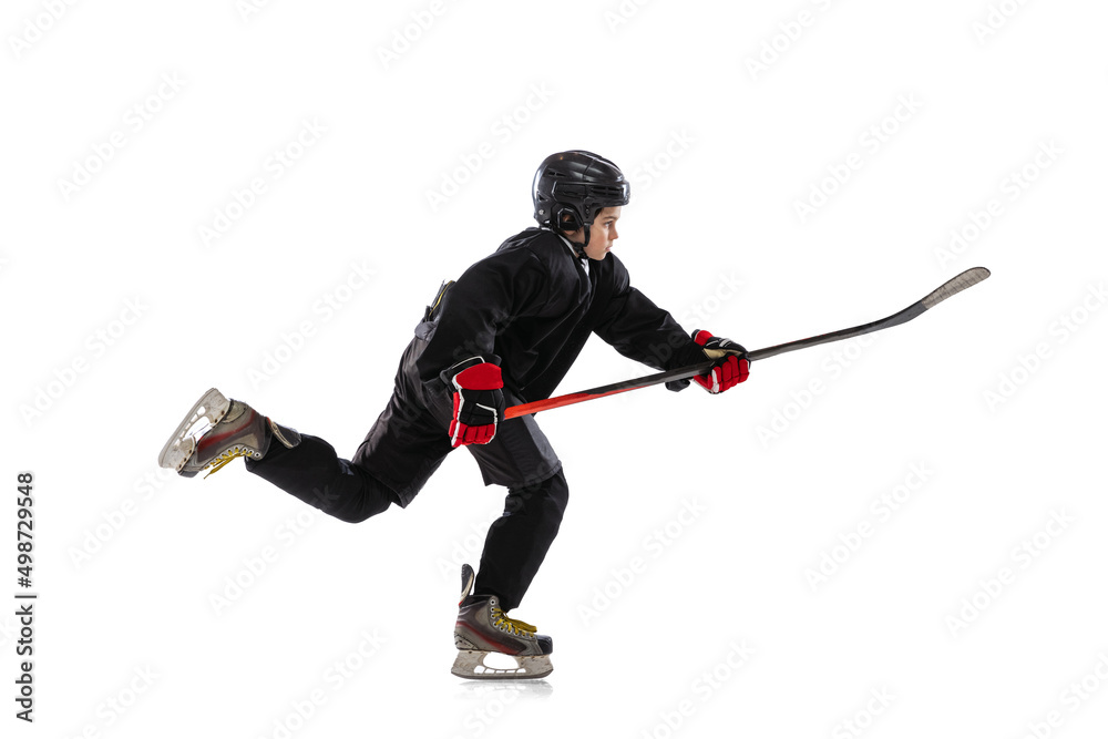 Little sportsman, hockey player training isolated over white studio background. Little sportsman, hockey player training isolated over white studio background.