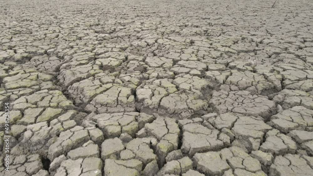 Cracked soil ground of dried lake or river. Aerial drone view of land destroyed by erosion and global warming. Ecological problem, drought, climate change, global warming concept. Environmental crisis Cracked soil ground of dried lake or river. Aerial drone view of land destroyed by erosion and global warming. Ecological problem, drought, climate change, global warming concept. Environmental crisis
