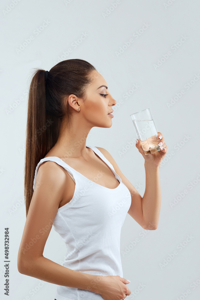 Beautiful woman holding water glass. Drink water. Girl with glass of water. Diet concept Beautiful woman holding water glass. Drink water. Girl with glass of water. Diet concept