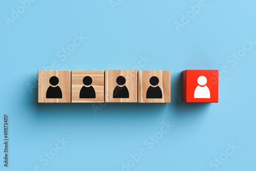 Wooden blocks with people icons with one standing out from the crowd on blue background. The concept of innovation, solutions, uniqueness, individuality and thinking differently. 3d rendering.
