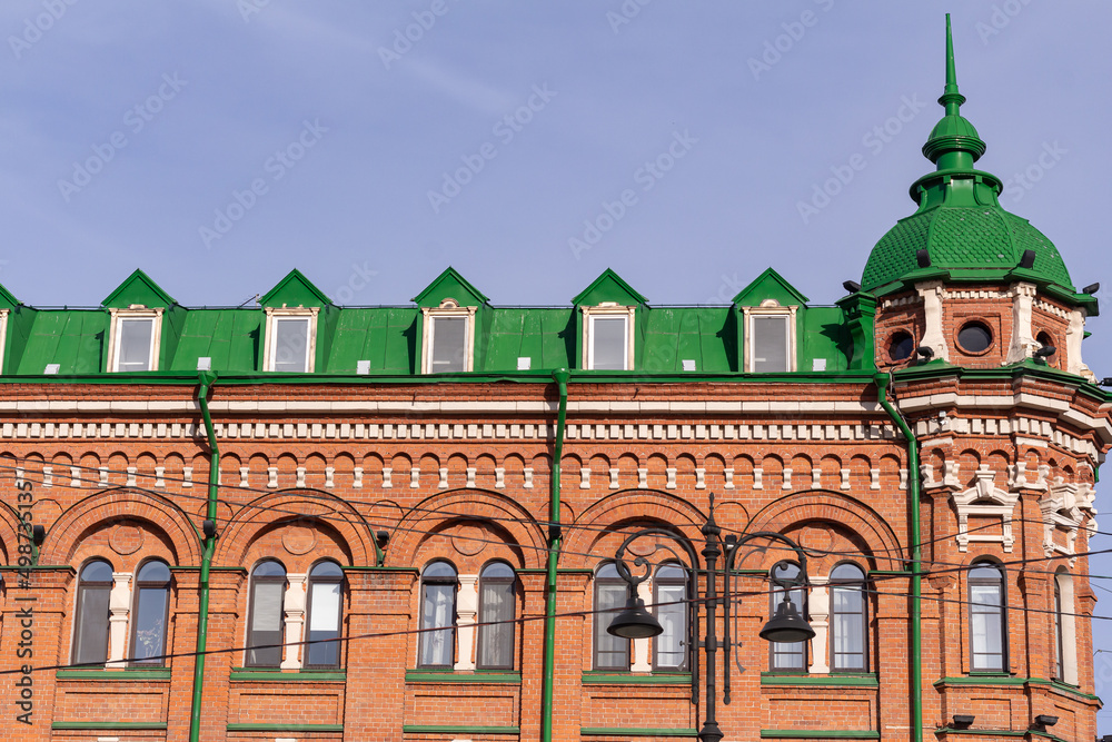 Obraz premium part of Facade of a red building with many windows. House facade of old historical building.